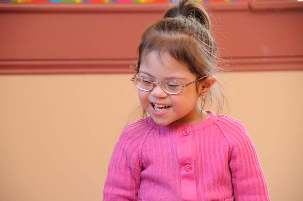 child with Down syndrome laughing