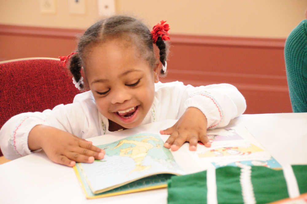Child with Down syndrome reading