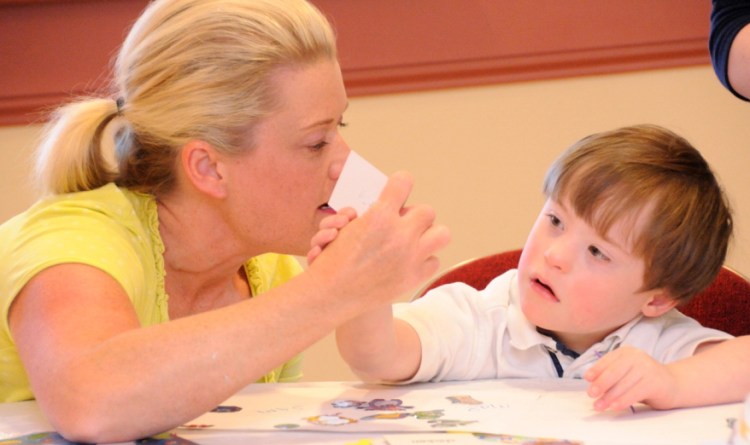 Child with Down syndrome reading