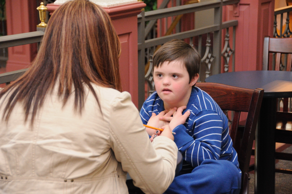 Child with Down syndrome reading