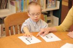 Child with Down syndrome reading